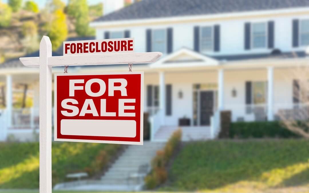 house for foreclosure with sale sign