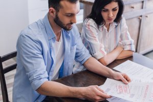 Man and woman reading foreclosure document