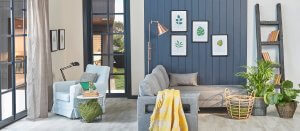 Modern blue room, grey sofa, yellow blanket and leaf frame, lamp