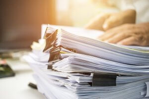 Photo of stack of papers to represent the paperwork used for Short Sales