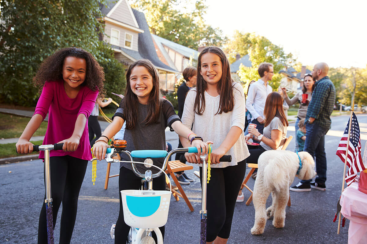 family biking in neighborhood uring the day