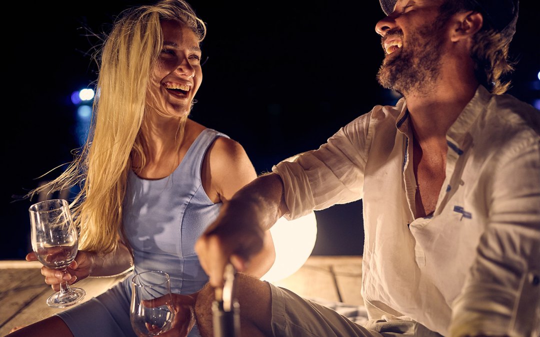 Couple on a date outside at night laughing